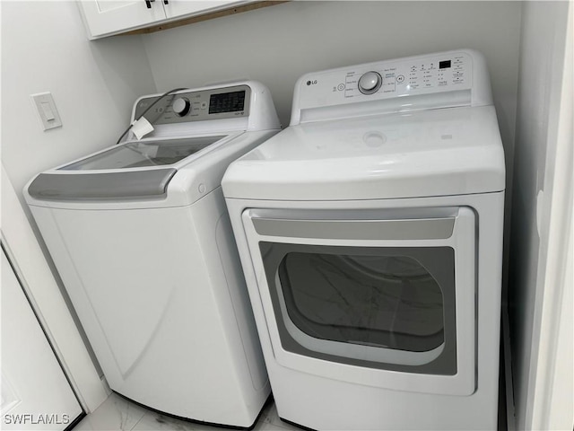 707 NE Juanita Place, Cape Coral, FL 33909 - laundry room with washing machine and clothes dryer