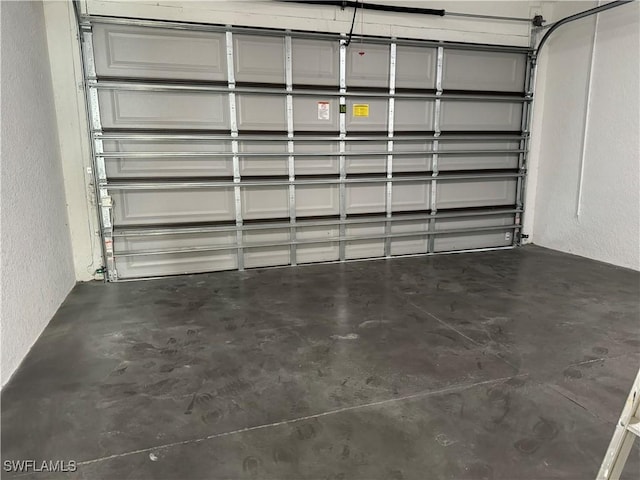 707 NE Juanita Place, Cape Coral, FL 33909 - garage with a textured wall