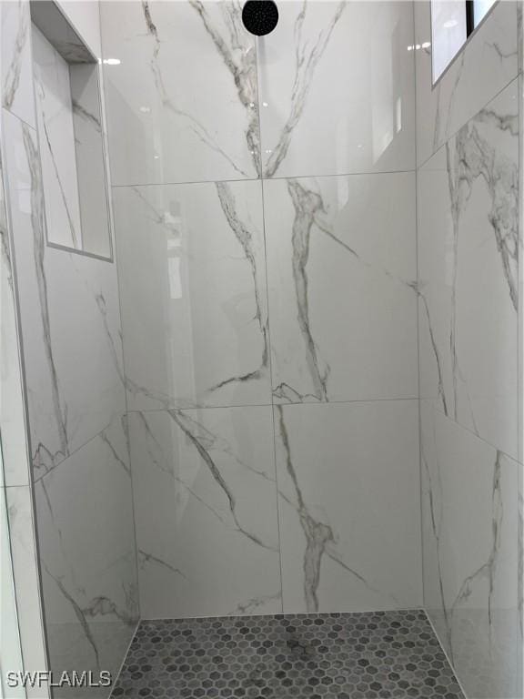 707 NE Juanita Place, Cape Coral, FL 33909 - bathroom featuring a marble finish shower