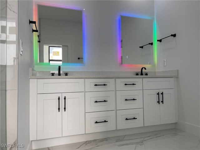 707 NE Juanita Place, Cape Coral, FL 33909 - bathroom featuring double vanity and marble look tiles