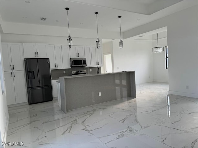707 NE Juanita Place, Cape Coral, FL 33909 - kitchen featuring stainless steel appliances, white cabinetry, decorative light fixtures, light marble finish floors, and recessed lighting