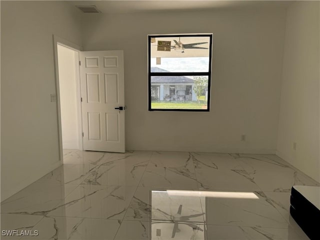 707 NE Juanita Place, Cape Coral, FL 33909 - spare room featuring baseboards and marble finish floors