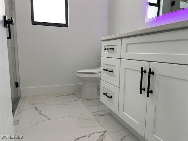 707 NE Juanita Place, Cape Coral, FL 33909 - bathroom featuring marble finish floors, vanity, and a shower with shower door