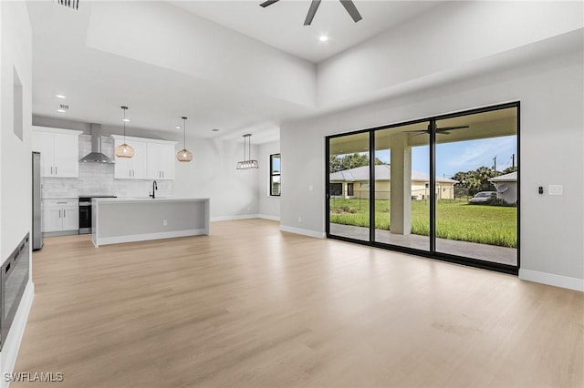 1299 Argosy Rd, Labelle, FL 33935 - unfurnished living room featuring ceiling fan, light wood-style flooring, and recessed lighting