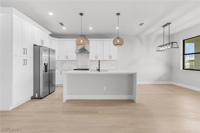 1299 Argosy Rd, Labelle, FL 33935 - kitchen featuring stainless steel fridge with ice dispenser, light wood-type flooring, tasteful backsplash, white cabinetry, and recessed lighting