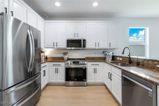 10490 Spruce Pine Ct, Fort Myers, FL 33913 - kitchen featuring appliances with stainless steel finishes, recessed lighting, white cabinets, and dark stone countertops