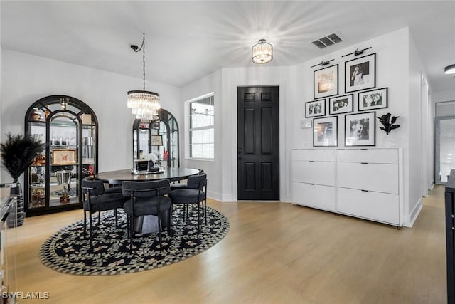 10490 Spruce Pine Ct, Fort Myers, FL 33913 - dining room with light wood finished floors and a chandelier