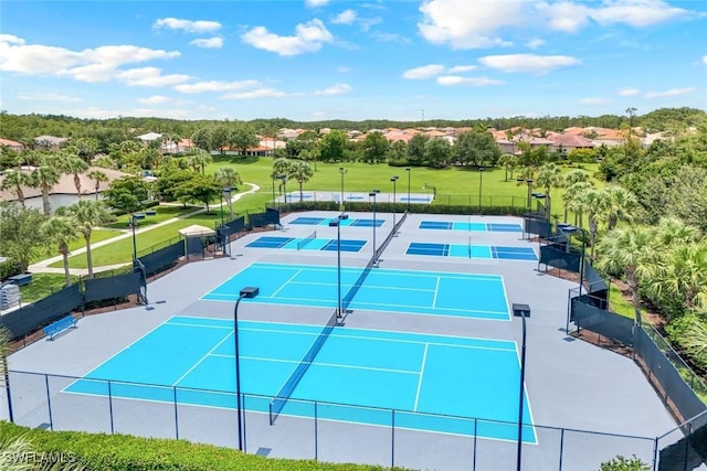 10490 Spruce Pine Ct, Fort Myers, FL 33913 - view of tennis court featuring view of scattered trees