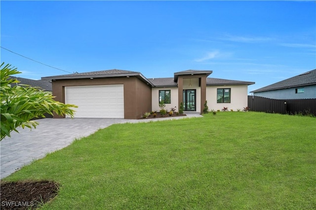 2018 Nelson Rd N, Cape Coral, FL 33993 - prairie-style home featuring an attached garage, stucco siding, and driveway