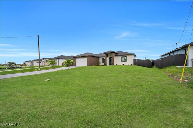 2018 Nelson Rd N, Cape Coral, FL 33993 - view of front facade with driveway, a garage, and stucco siding