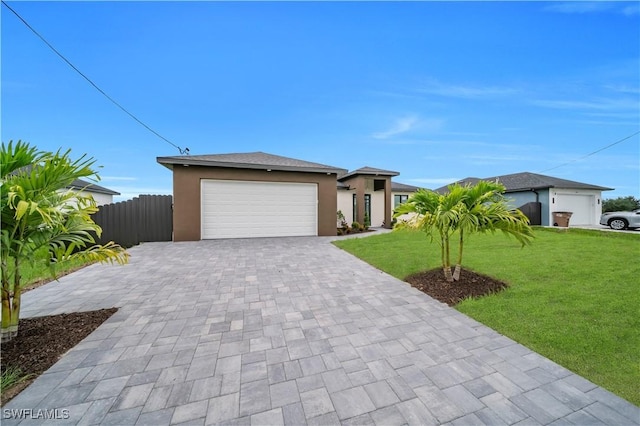 2018 Nelson Rd N, Cape Coral, FL 33993 - view of front of property with a garage, decorative driveway, and stucco siding
