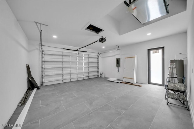 2018 Nelson Rd N, Cape Coral, FL 33993 - garage featuring recessed lighting, electric panel, and a garage door opener