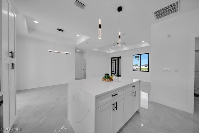 2018 Nelson Rd N, Cape Coral, FL 33993 - kitchen with a tray ceiling, white cabinetry, light marble finish floors, open floor plan, and recessed lighting