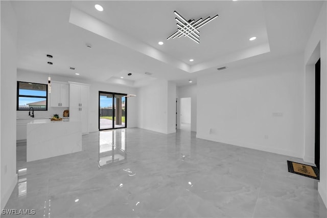 2018 Nelson Rd N, Cape Coral, FL 33993 - spare room featuring recessed lighting, a tray ceiling, and light marble finish flooring