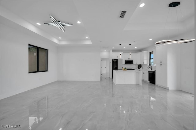 2018 Nelson Rd N, Cape Coral, FL 33993 - unfurnished living room featuring a tray ceiling, recessed lighting, and light marble finish floors