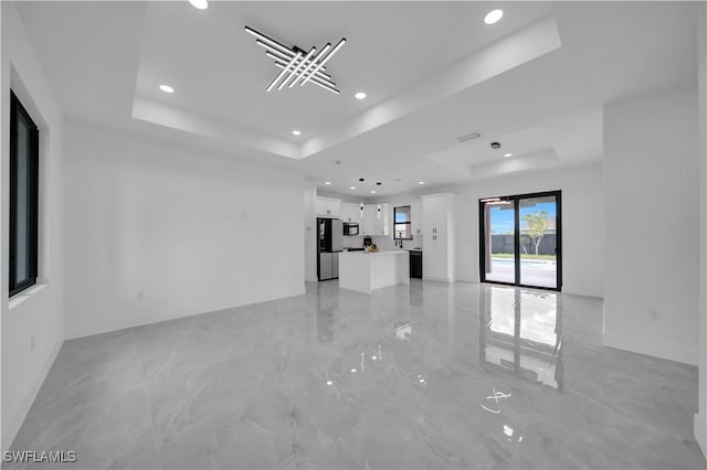 2018 Nelson Rd N, Cape Coral, FL 33993 - unfurnished living room with a raised ceiling, recessed lighting, and light marble finish flooring