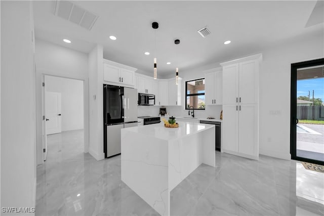 2018 Nelson Rd N, Cape Coral, FL 33993 - kitchen featuring stainless steel microwave, fridge, dishwasher, healthy amount of natural light, and recessed lighting