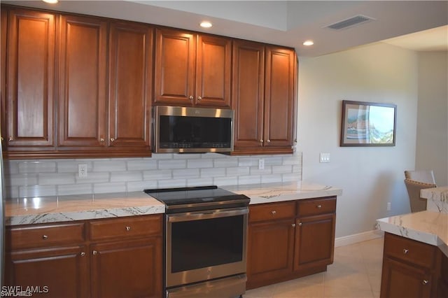 4182 Bay Beach Ln Unit 752, Fort Myers Beach, FL 33931 - kitchen featuring appliances with stainless steel finishes, tasteful backsplash, light stone countertops, recessed lighting, and light tile patterned flooring