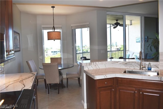 4182 Bay Beach Ln Unit 752, Fort Myers Beach, FL 33931 - kitchen featuring light tile patterned flooring, ceiling fan, pendant lighting, and light stone countertops