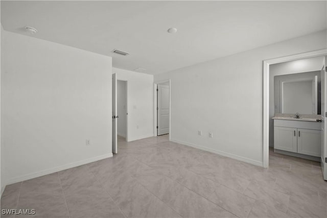 17620 Monte Isola Way N, Fort Myers, FL 33917 - unfurnished bedroom featuring a sink and connected bathroom