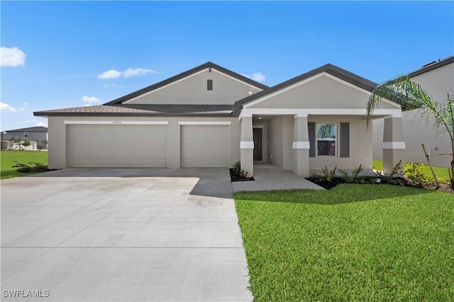 17620 Monte Isola Way N, Fort Myers, FL 33917 - single story home with stucco siding, a garage, driveway, and a front yard