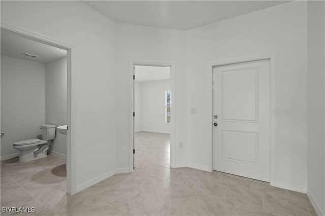 17620 Monte Isola Way N, Fort Myers, FL 33917 - hallway with light tile patterned flooring and baseboards