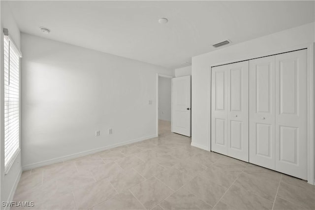 17620 Monte Isola Way N, Fort Myers, FL 33917 - unfurnished bedroom with a closet and baseboards