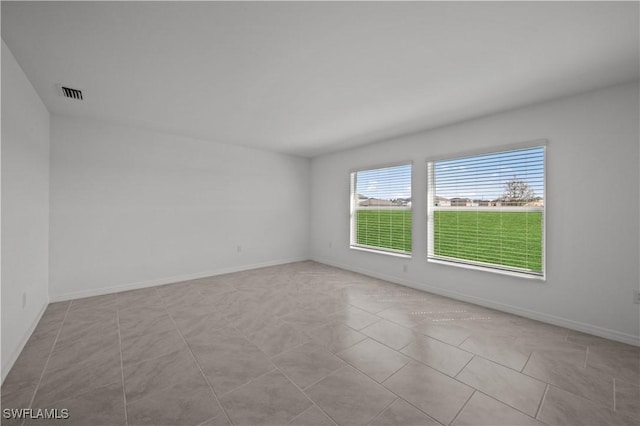 17620 Monte Isola Way N, Fort Myers, FL 33917 - tiled empty room featuring baseboards