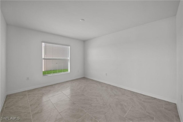 17620 Monte Isola Way N, Fort Myers, FL 33917 - unfurnished room with baseboards and light tile patterned floors