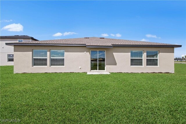 17620 Monte Isola Way N, Fort Myers, FL 33917 - back of property with a lawn, stucco siding, and roof with shingles