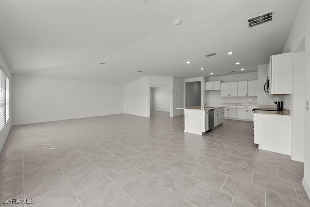 17620 Monte Isola Way N, Fort Myers, FL 33917 - kitchen featuring open floor plan, white cabinetry, recessed lighting, a kitchen island with sink, and appliances with stainless steel finishes
