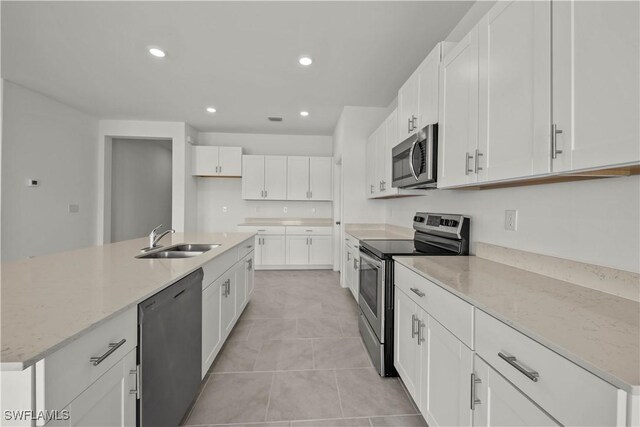 17620 Monte Isola Way N, Fort Myers, FL 33917 - kitchen featuring appliances with stainless steel finishes, recessed lighting, light stone counters, white cabinets, and light tile patterned floors
