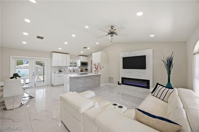 5245 23rd Ave SW, Naples, FL 34116 - living room with light marble finish floors, ceiling fan, lofted ceiling, a premium fireplace, and recessed lighting