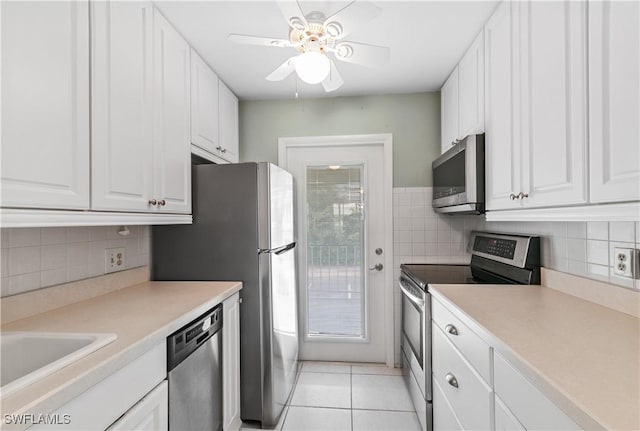 418 12th Ave S Unit C418, Naples, FL 34102 - kitchen featuring appliances with stainless steel finishes, white cabinets, light tile patterned floors, a ceiling fan, and light countertops