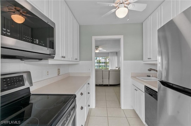 418 12th Ave S Unit C418, Naples, FL 34102 - kitchen featuring stainless steel appliances, a ceiling fan, light tile patterned flooring, and light countertops