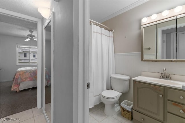 418 12th Ave S Unit C418, Naples, FL 34102 - bathroom featuring vanity, a textured ceiling, ensuite bath, wainscoting, and tile patterned flooring