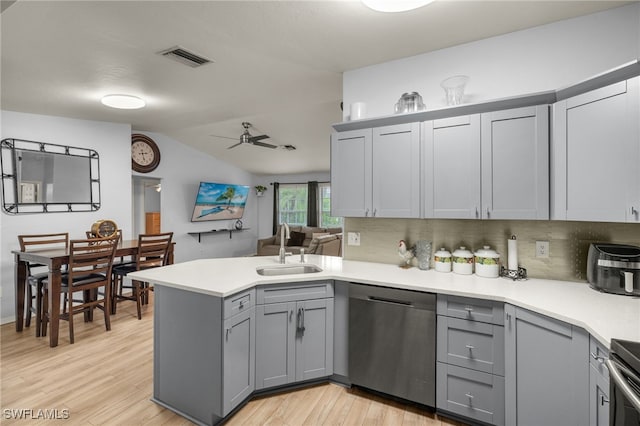 343 Golden Gate Blvd E, Naples, FL 34120 - kitchen with stainless steel dishwasher, gray cabinetry, a peninsula, light wood-type flooring, and vaulted ceiling