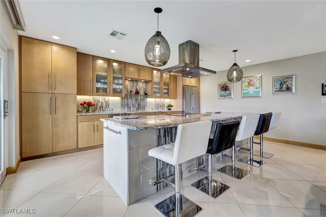 7105 Quail Run Ct W Unit 4, Fort Myers, FL 33908 - kitchen featuring high end fridge, island range hood, light stone countertops, a breakfast bar area, and recessed lighting