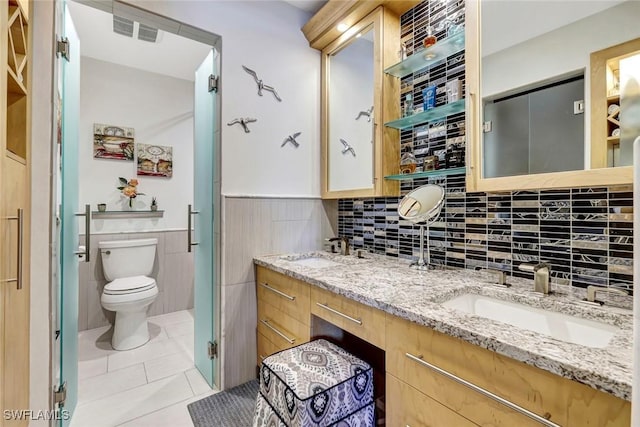 7105 Quail Run Ct W Unit 4, Fort Myers, FL 33908 - bathroom with tile patterned floors, double vanity, wainscoting, and tile walls
