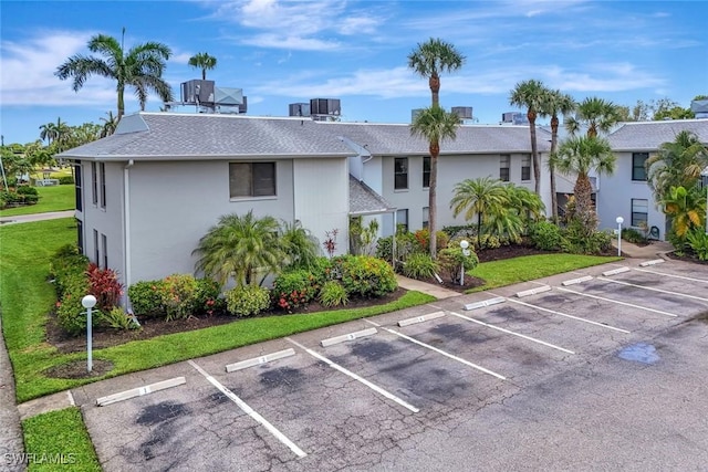 7105 Quail Run Ct W Unit 4, Fort Myers, FL 33908 - view of front of property with uncovered parking and roof with shingles