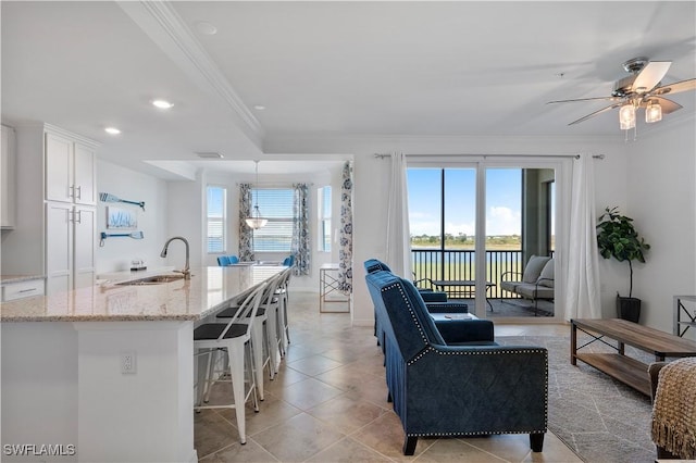 43040 Greenway Blvd Unit 536, Punta Gorda, FL 33982 - living area featuring ornamental molding, plenty of natural light, a ceiling fan, light tile patterned floors, and recessed lighting
