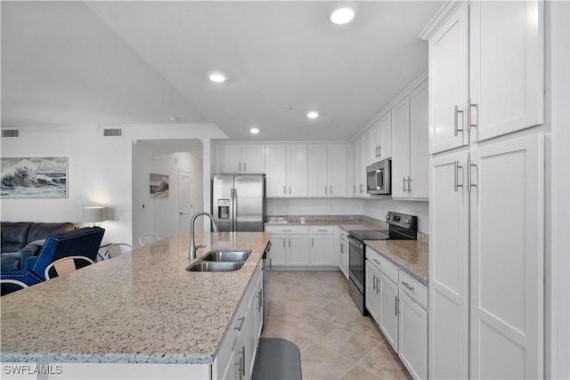 43040 Greenway Blvd Unit 536, Punta Gorda, FL 33982 - kitchen featuring stainless steel appliances, white cabinets, recessed lighting, open floor plan, and a kitchen island with sink