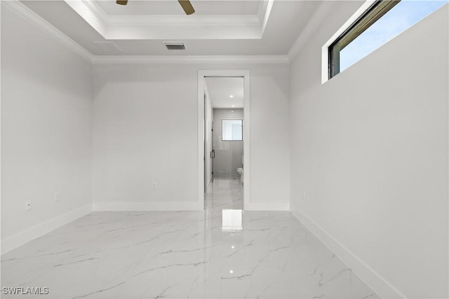 4371 47th Ave NE, Naples, FL 34120 - unfurnished room with marble finish flooring, a ceiling fan, a tray ceiling, and crown molding