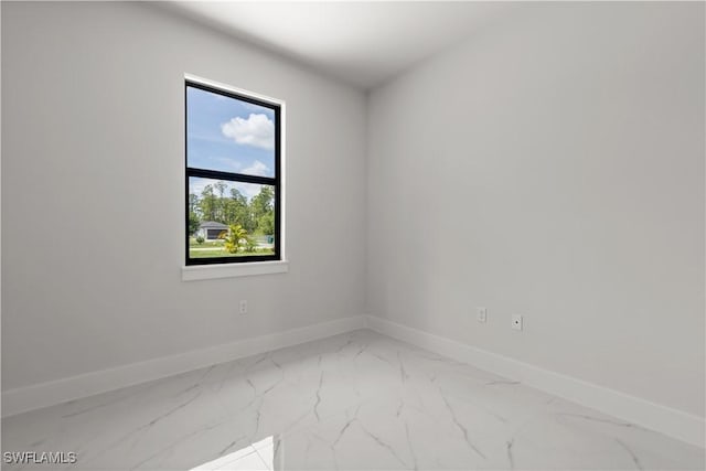 4371 47th Ave NE, Naples, FL 34120 - spare room with marble look tiles and baseboards