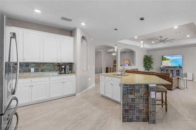 14659 Adina Ln, Fort Myers, FL 33905 - kitchen with ceiling fan, stainless steel refrigerator, arched walkways, open floor plan, and recessed lighting
