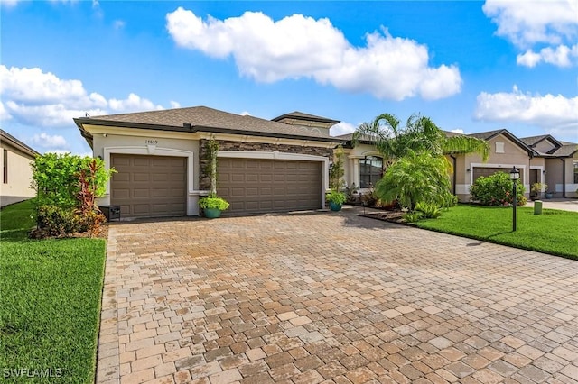 14659 Adina Ln, Fort Myers, FL 33905 - view of front of house featuring decorative driveway, a garage, a front yard, and stucco siding