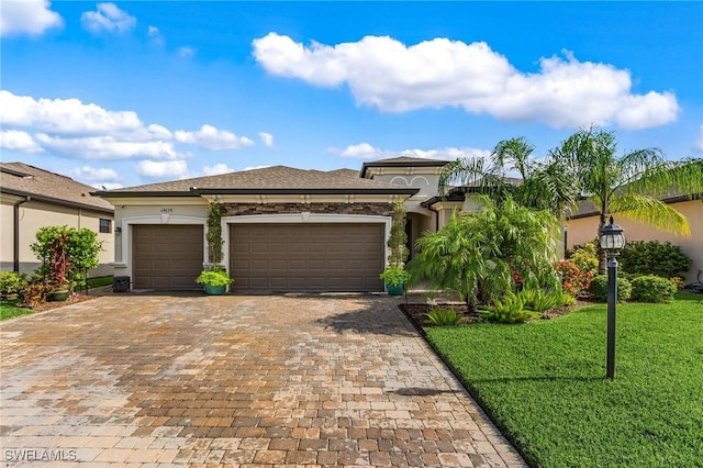 14659 Adina Ln, Fort Myers, FL 33905 - view of front facade featuring stucco siding, a front lawn, a garage, and decorative driveway