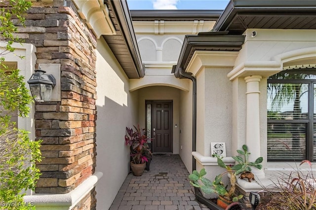 14659 Adina Ln, Fort Myers, FL 33905 - entrance to property featuring stucco siding, stone siding, and a surveillance system