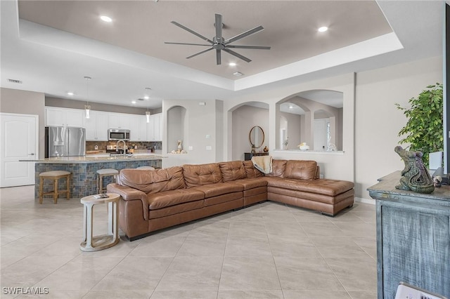14659 Adina Ln, Fort Myers, FL 33905 - living room with a tray ceiling, ceiling fan, light tile patterned floors, and recessed lighting