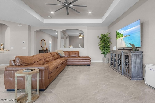 14659 Adina Ln, Fort Myers, FL 33905 - living area with ceiling fan, a raised ceiling, arched walkways, light tile patterned flooring, and recessed lighting